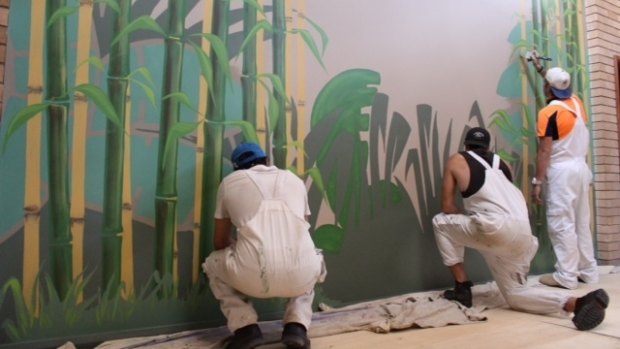 Painting of a mural at the Lalor Park Community Hub in March.