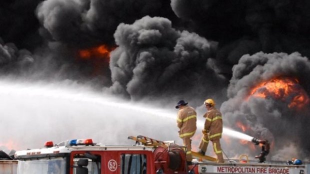 Firefighters fight to control the tyre fire in Broadmeadows, Melbourne on Monday.