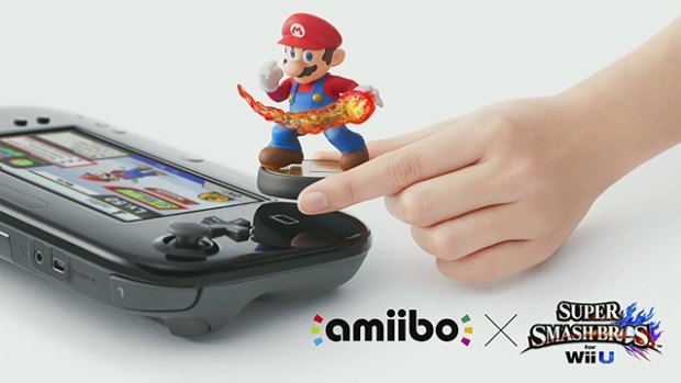 A Mario Amiibo figurine is used with <i>Super Smash Bros for Wii U</i>.