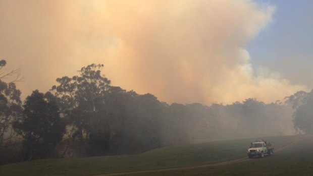 Parks Victoria keep a close eye on the Lancefield-Cobaw fire as it approaches a home on Burke and Wills track, Benloch, on Thursday.