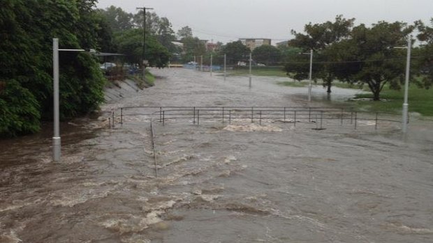 A swollen stormwater drain floods the bike path in Annerley.