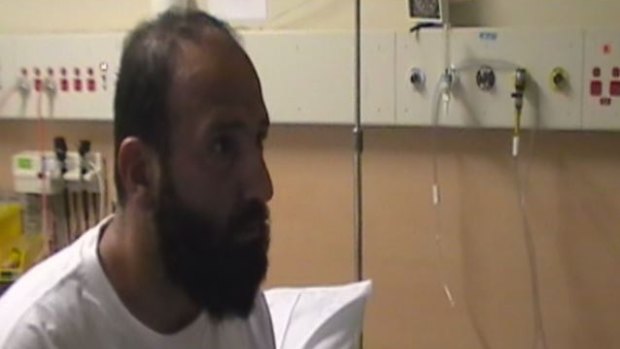 A still from the police video where Monis is told while in hospital that his ex-wife is dead.