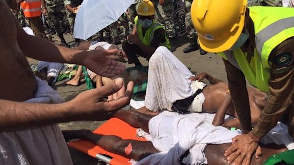 An emergency worker performs CPR on a pilgrim at Mecca.