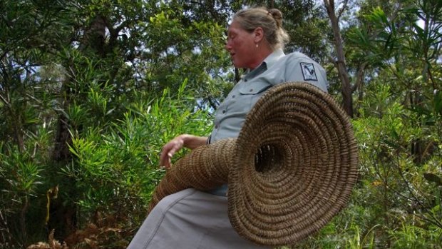 Indigenous educator 'Aunt Julie' with a traditional eel trap.