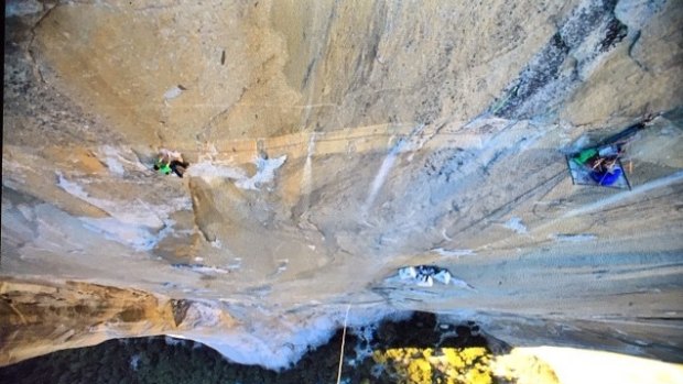 Kevin Jorgeson climbs on the left as Tommy Caldwell rests on the right.  