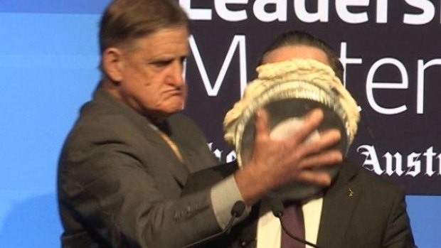 Alan Joyce hit with a pie during an event in Perth.