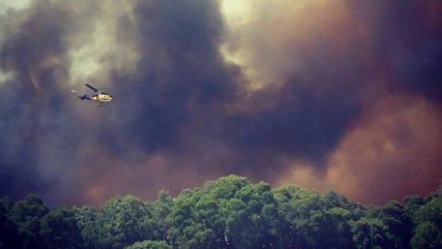 A firefighting helicopter tackles the Bullsbrook blaze.