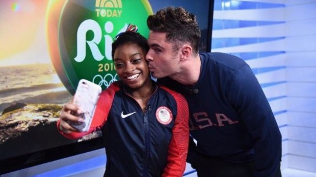 Zac Efron surprised US gymnast Simone Biles by flying to Rio to watch her compete.