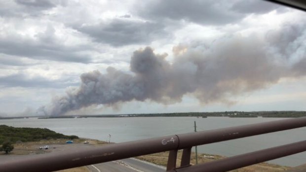 Views from Stockton Bridge of smoke rising from the bushfire which is moving east towards Newcastle Airport.