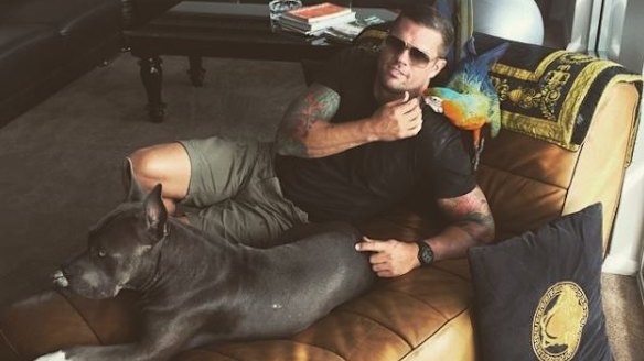 Darren Mohr poses in his Vaucluse apartment with his macaw Paris.