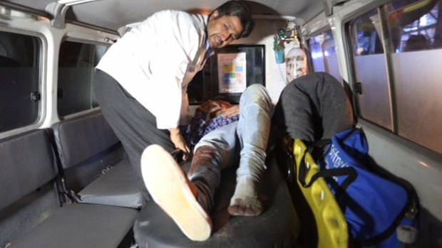 A wounded person is treated in an ambulance after an attack on the American University in the Afghan capital Kabul.