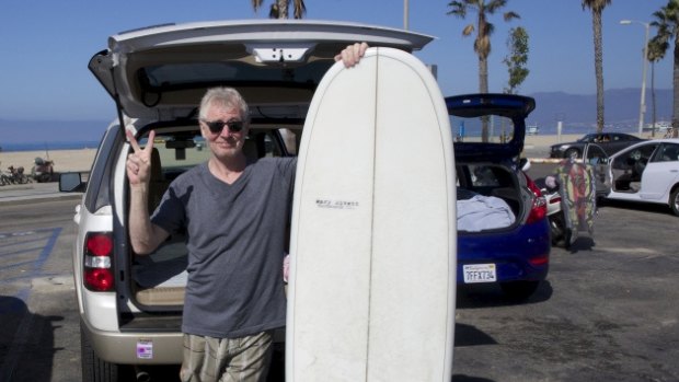 Neil Lawrence with his new surfboard in Santa Monica, Los Angeles.