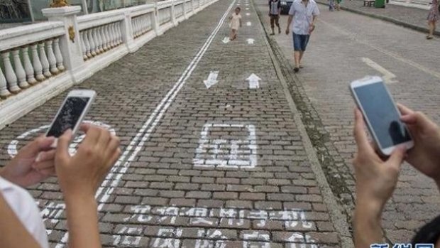 Mobile phone lanes for texters in the Chinese city of Chongqing.
