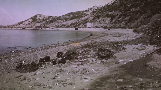 A view of Anzac Cove as it appeared in February, 1919. Debris in the foreground includes barbed wire and two water cans. 