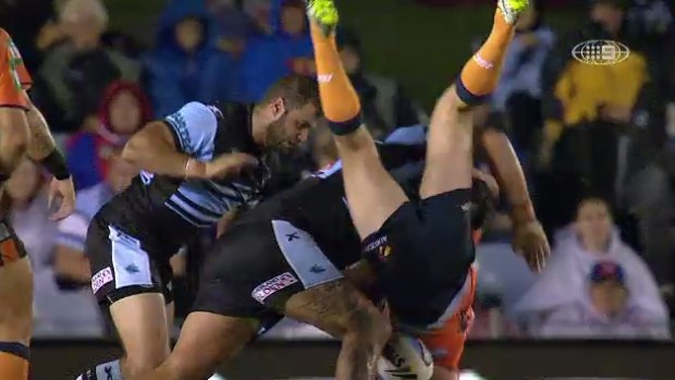 Newcastle hooker Adam Clydsdale is upended by Sharks prop Andrew Fifita.