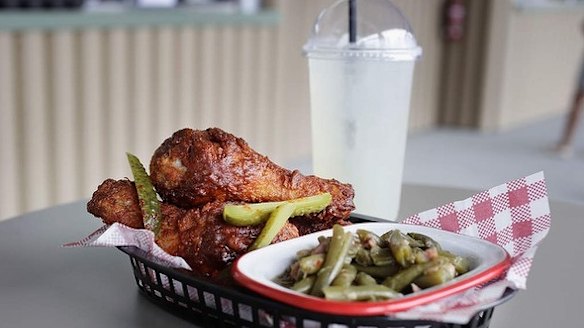 Chicken drumsticks and greens with lemonade at Belles Hot Chicken in Barangaroo. 