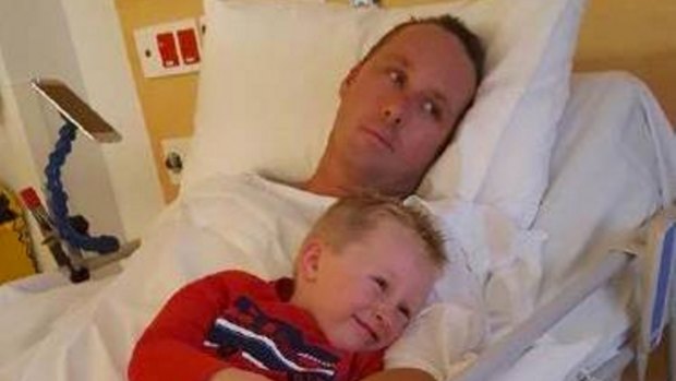 Family: Zayb Jobson cuddles up to his father in hospital as the footballer continues his recovery.