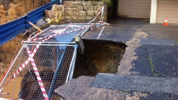 Part of the driveway of a unit block collapsed.