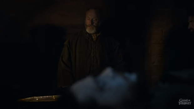 Davos Seaworth standing over Snow's lifeless body.