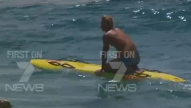 Camera-shy Gold Coast lifeguard Nick Malcolm has declined to comment on his high-profile rescue.