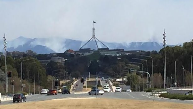 Smoke from a hazard reduction burns rises over Canberra.