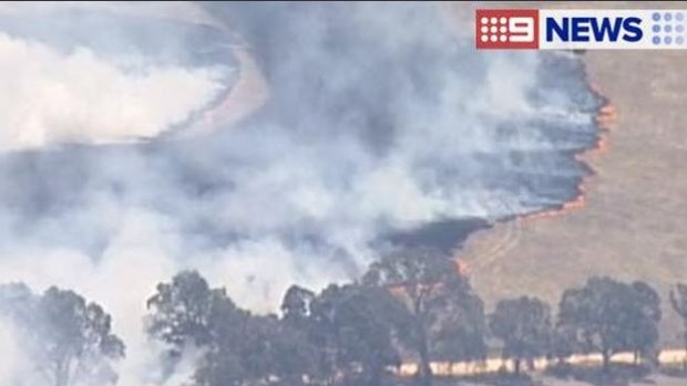 The grassfire is moving in a south-easterly direction.