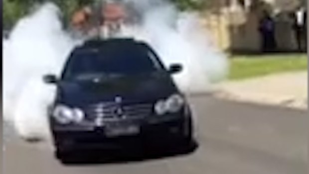 A car doing a burnout as part of the wedding 'celebrations'.