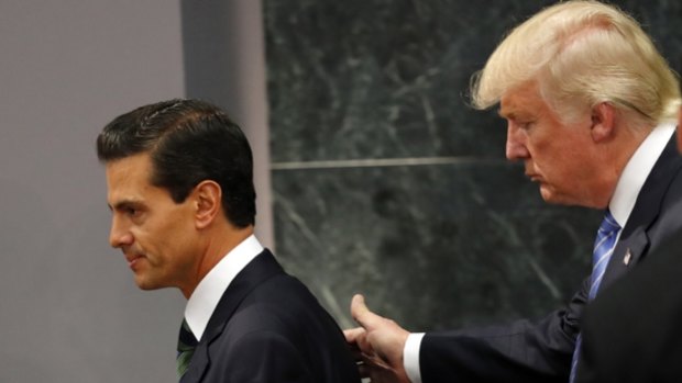Donald Trump walks with Mexican President Enrique Pena Nieto, during a Presidential campaign visit.