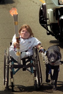 ME.torch.1.0427.RG  Melanie Watson is pulled along Western Avenue by her dog "Roamer," during the first day of the cross country Olympic Torch Relay, Saturday, April 27, 1996.