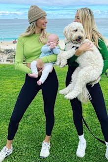 Married At First Sight's Sharon and her twin sister Michelle from Season 4 posing with dog and child.