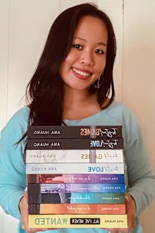 Ana Huang poses with her novels.