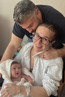 Jackie Miller James with her baby and husband after suffering an aneurysm rupture at nine months pregnant.