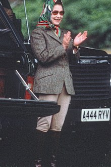 Queen Elizabeth ll, wearing jodhpurs and a headscarf, relaxes during Windsor Horse Show  on May 13, 1988 in Windsor, England. (Photo by Anwar Hussein/Getty Images)