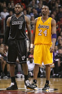 In this 2012 photo, Miami Heat's LeBron James and Los Angeles Lakers' Kobe Bryant look on during the third quarter of an NBA basketball game in Miami.