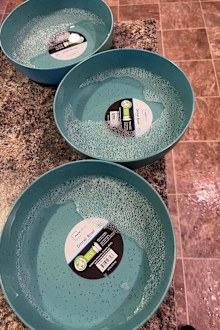 Bowls filled with hot soapy water to help remove label.