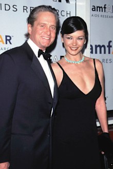 Michael Douglas and his fiancee Catherine Zeta-Jones smile at an "AMFAR" benefit November 30, 1999 in New York. 