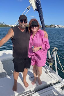 Shelly Horton standing with partner, posing for photo on a boat at her Christmas party 2022.