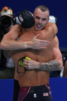 Kyle Chalmers (R) of Team Australia embraces Caeleb Dressel of Team United States after competing in the Men's 100m Freestyle Final.