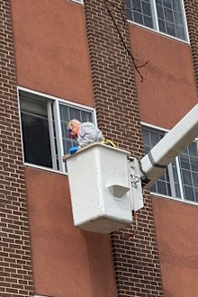 Nick was launched into the air to see his wife on a cherry picker with the help of his son Chris.
