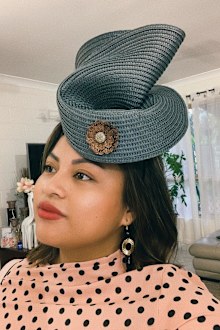 Woman fashions fascinator from $5 Kmart placemat for Melbourne Cup day.