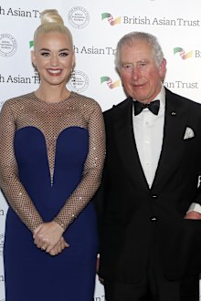 Prince of Wales, Royal Founding Patron, the British Asian Trust, meets musician Katy Perry, left, as he arrives to attend a reception for supporters of the British Asian Trust in London, Tuesday, Feb. 4, 2020.
