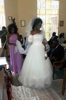 In this photo taken on Saturday, May, 5, 2018, Zenele Ndlovu walks down the aisle on her wedding day at a hospital Chapel in Bulawayo, Zimbabwe. Ndlovu and Jamie Fox, attacked by a crocodile, wedded days later in a Zimbabwean hospital, where Ndlovu was recovering after losing an arm. "In one week we went from shock and agony to a truly amazing experience," Fox told The Associated Press on Monday, May 7. (AP Photo)
