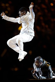 Usher, top, performs with the Black Eyed Peas' will.i.am during halftime of the NFL football Super Bowl XLV game between the Green Bay Packers and the Pittsburgh Steelers on Sunday, Feb. 6, 2011, in Arlington, Texas. 