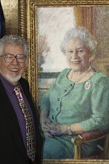 Artist Rolf Harris stands with his portrait of Britain's Queen Elizabeth II, at its unveiling at Buckingham Palace, London, Monday Dec. 19, 2005. 