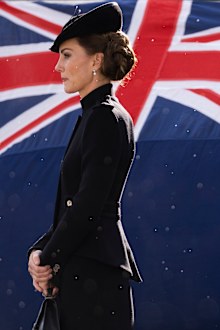 Catherine, Princess of Wales walks past a Union flag as rain falls while meeting with military personnel during a visit to Army Training Centre Pirbright on September 16, 2022 in Guildford, England. 