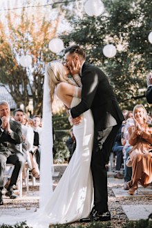 Hannah and Simon kiss on their wedding day.