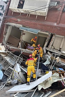 Members of a search and rescue team prepare to enter a leaning building in the aftermath of an earthquake in Hualien, eastern Taiwan on Wednesday, April 3, 2024.  