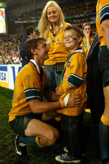 Mat Rogers of the Wallabies with his son and wife after the 2003 Rugby World Cup final.