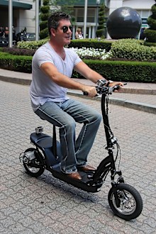 Simon Cowell, riding scooter, Boston, June 28, 2012.