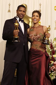 Actor and Actress in a Leading Role winners Denzel Washington and Halle Berry pose with their Oscars backstage in 2002.